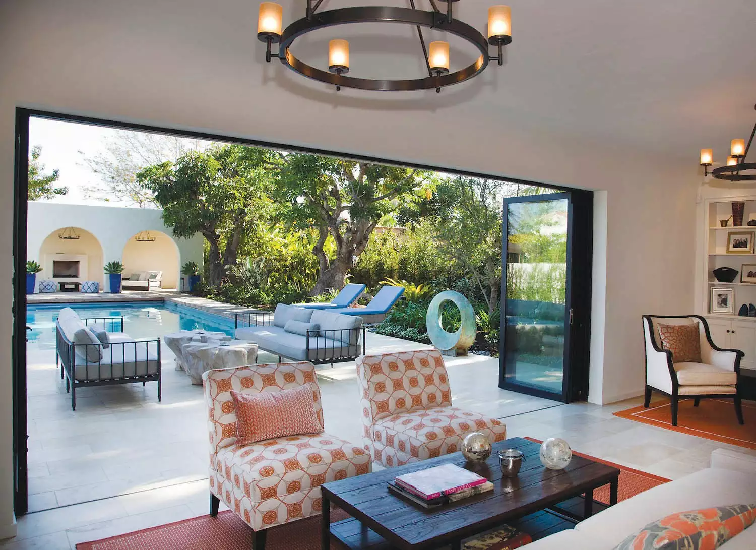 Interior Living Area featuring Large Open Doors Leading to Outdoor Living Area and Pool