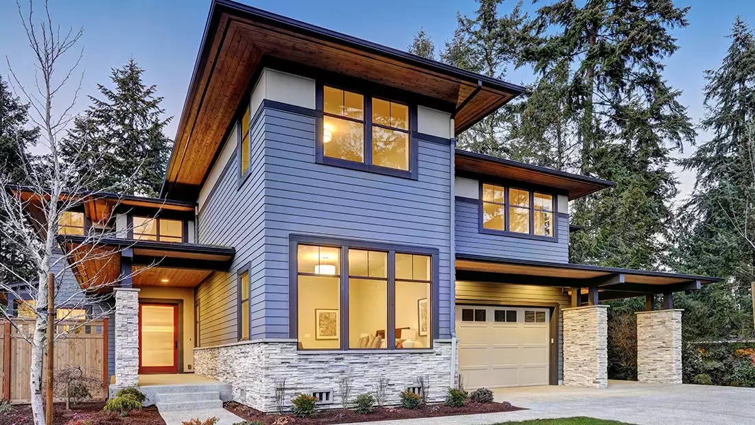 Modern House Exterior featuring Horizontal Blue Siding and Stone Columns/Base