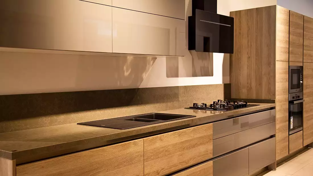 Modern streamlined kitchen with clean lines and minimalist wood cabinetry and countertops.
