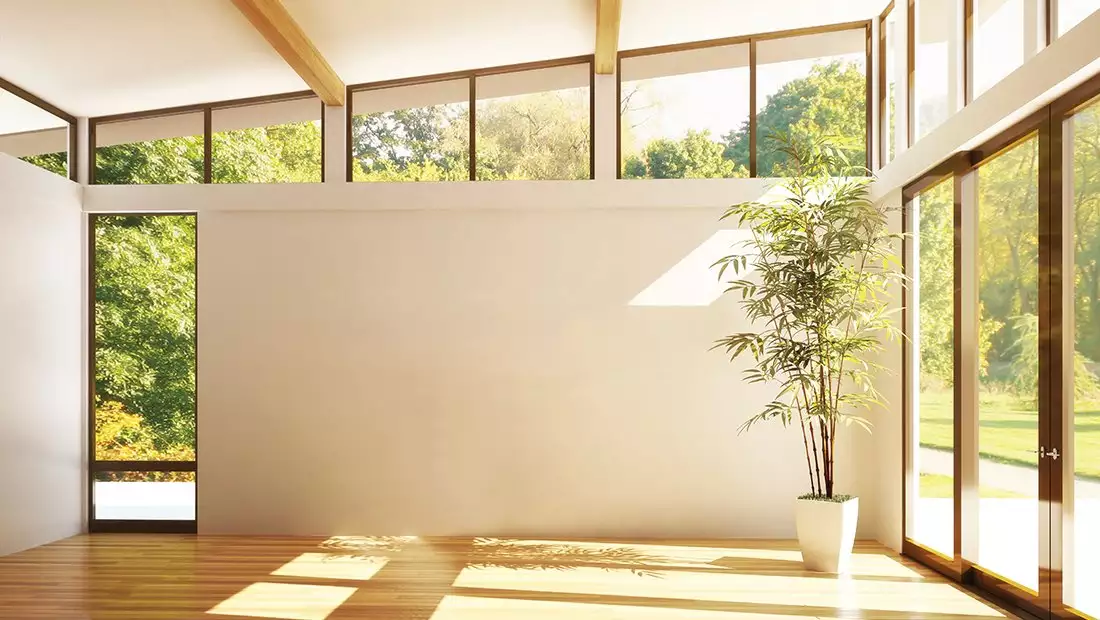Open-Spaced Room featuring Large Windows and Warm Wood Floors